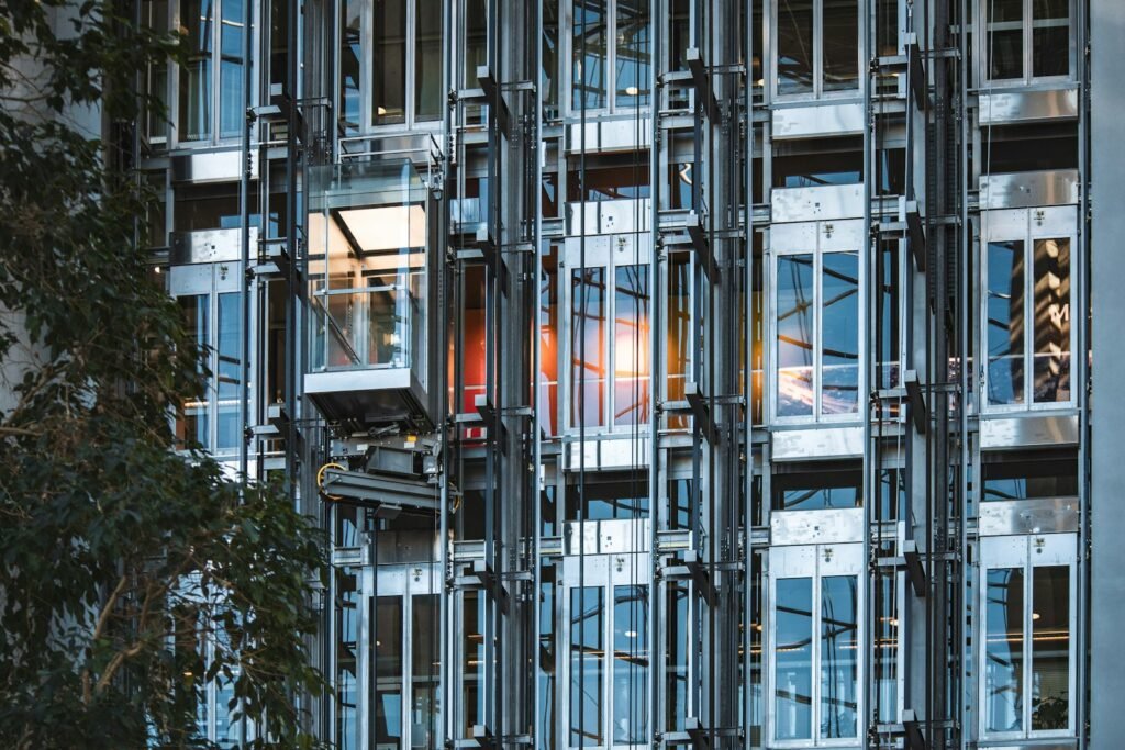 Glass elevator shafts on a modern building facade